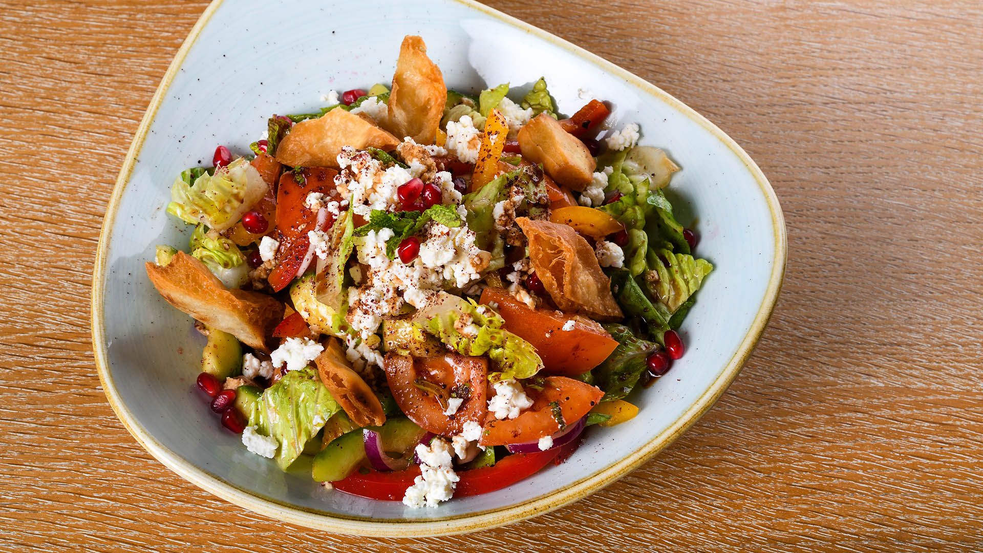 Fattoush is a Levantine salad made from toasted or fried pieces of khubz combined with mixed greens and other vegetables © Cristina.A/Shutterstock