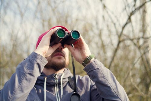 man-binoculars-birdwatching-shutterstock_1087826783